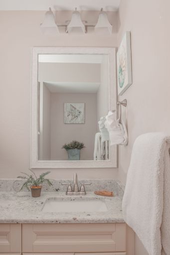 A vertical shot the white interior of a wash basin in the bathroom