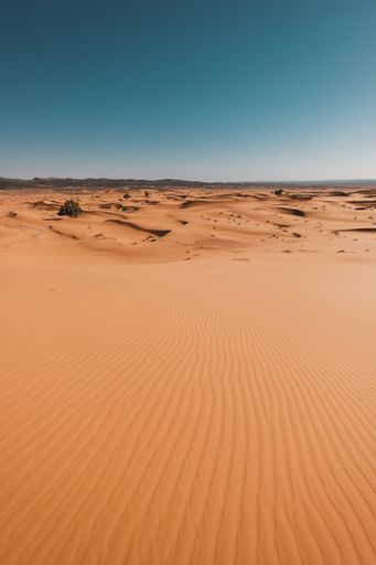 A vertical shot of the breathtaking desert under the blue sky captured in Morocco