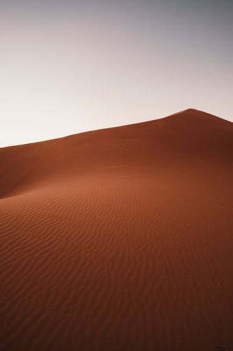 A vertical shot of the breathtaking desert under the blue sky captured in Morocco