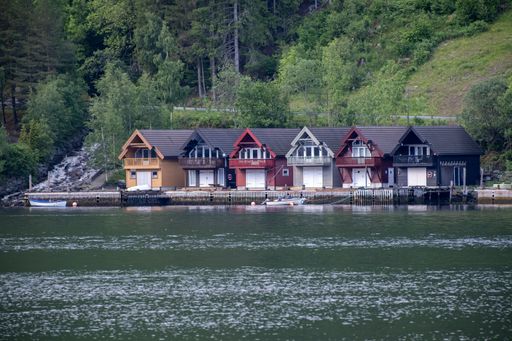 Vikoyri, Norway - June 18, 2022: Wonderful landscapes in Norway. Vestland. Beautiful scenery of coloured houses facing the spectacular Sognefjord.