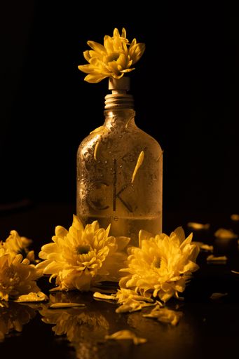 A vertical shot of the Calvin Klein One perfume with flower decorations and dim lighting