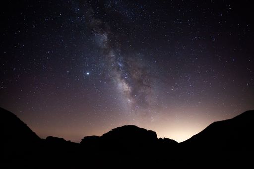 A perfect milky way over a silhouette of mountains in Sierra Nevada, Spain