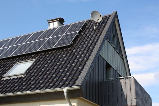 A closeup shot of solar panels on a residential house roof during the day time