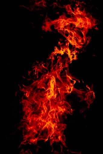 A beautiful vertical shot of a large burning fire at night