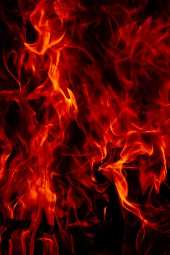 A beautiful vertical shot of a large burning fire at night