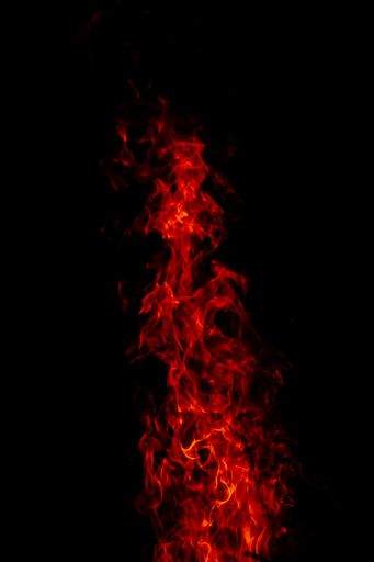 A beautiful vertical shot of a large burning fire at night