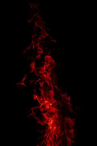 A beautiful vertical shot of a large burning fire at night