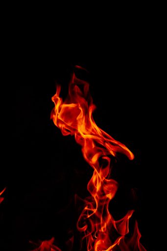 A beautiful vertical shot of a large burning fire at night