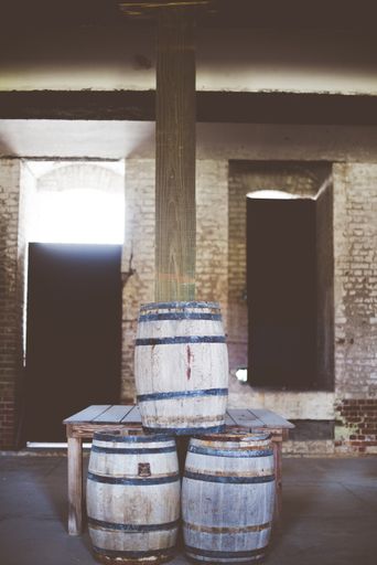A vertical shot of wooden barrels on top of each other with a blurred background