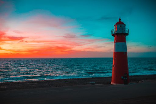 A lighthouse on the beach with the beautiful colorful sky captured in Zeeland, Netherlands