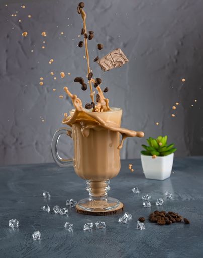 A vertical shot of a splashing mocaccino coffee