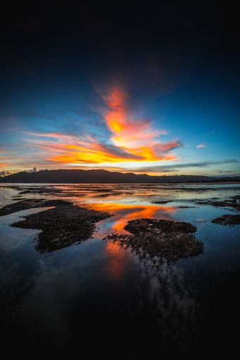 A vertical view of the reflection of the sky and clouds in the lake captured in Lombok, Indonesia