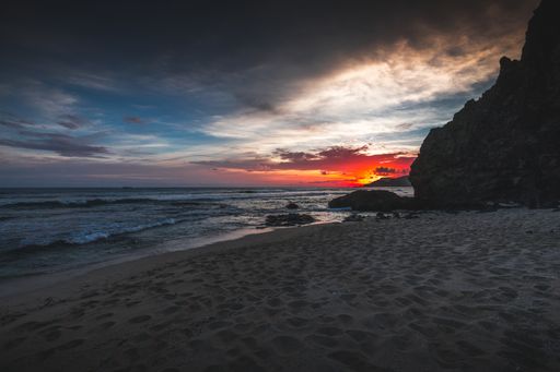 A beautiful view of the beach and the wavy ocean at sunset captured in Lombok, Indonesia