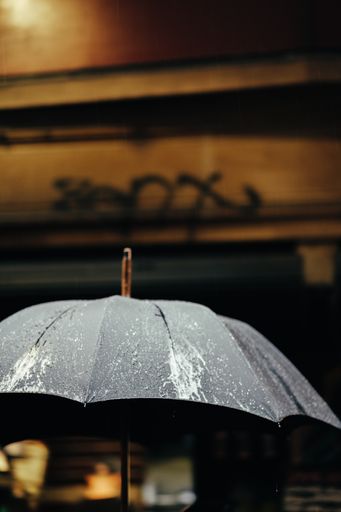 A wet black stained umbrella after rain