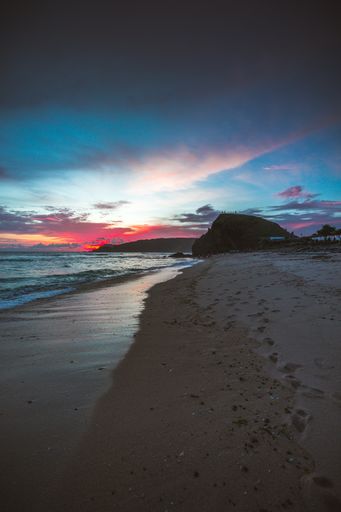 A vertical shot of the beautiful beach under the cloudy sky captured in Lombok, Indonesia
