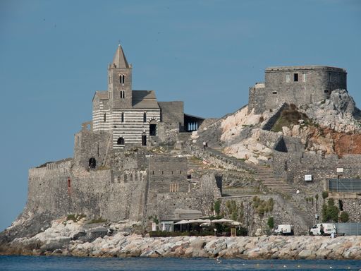 An image of a grey building in front of the Mediterranean Sea in Porto Venere, Italy