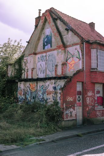 A vertical shot of a broken down abandoned building in Doel, Belgium