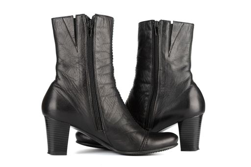 Women's black autumn ankle boots with a medium heel and a zipper. One pair on a white background. Focus in the foreground.