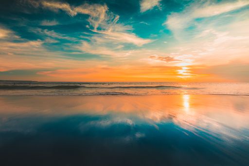 A breathtaking view of the reflection of the sun and the sky on the beach captured in Bali