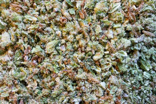 A closeup shot of ground cannabis with buds