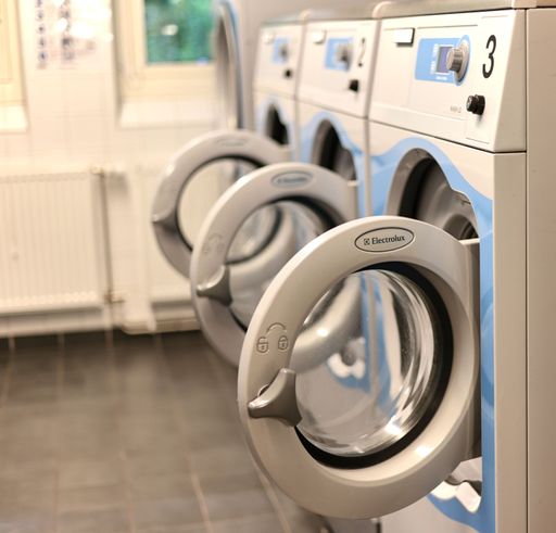 A row of Electrolux Stockholm washing machines in a laundromat