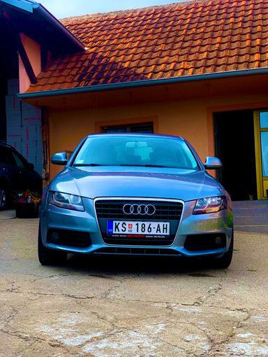 A vertical shot of a silver Audi S4 car on a porch