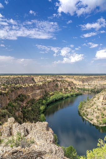 A vertical shot of the beautiful Duraton River surrounded by gorges in a natural park in Spain