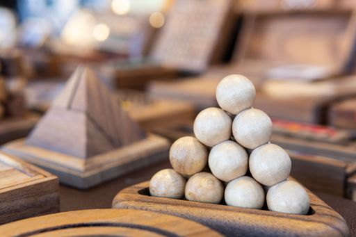 Handmade wooden puzzles on the table, copy spa