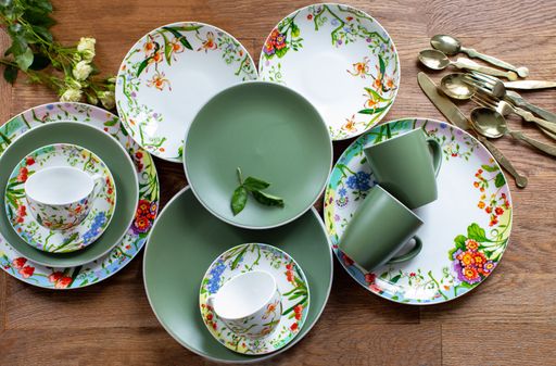 A top view of a beautiful set of clean tableware on a wooden table