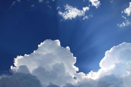 A beautiful blue sky with sunlight coming through clouds