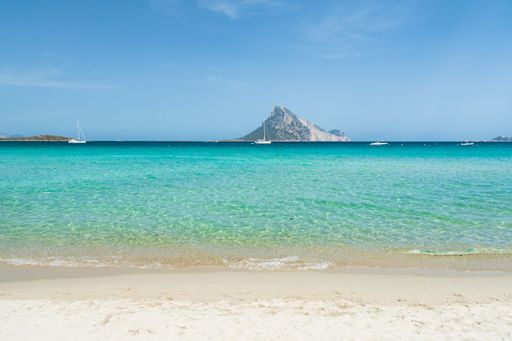 A landscape of the Sardinian sea surrounded by a beach near Porto Taverna, Italy