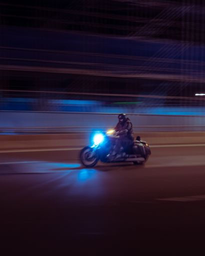 A biker on a motorcycle on the road shot in fast motion