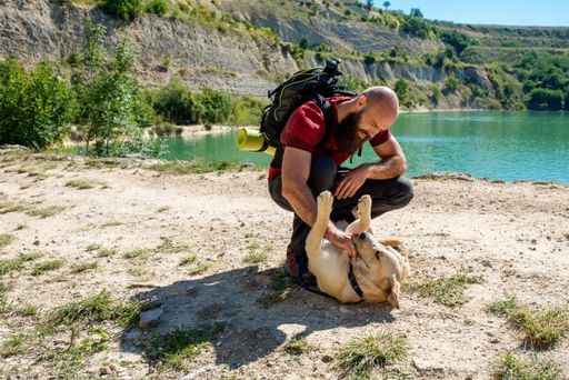 A young Caucasian male tourist exploring beautiful places with his dog