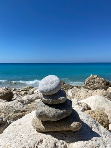 A closeup shot of  stones stack on beach by the sea background in Lefkada, Greece
