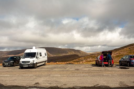 The cars and vans parked at the Scottish highlands