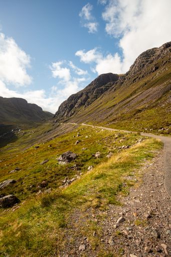 A vertical shot of a bright sunny day in a countryside mountainous landscape