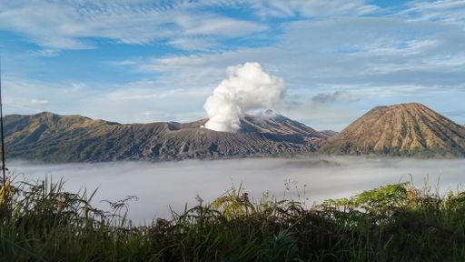The active somma volcano Mount Bromo in East Java, Indonesia with steam rising from the peak