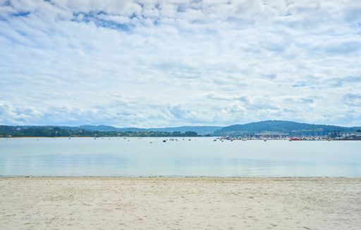 A beautiful shot of a calm beach under a bright cloudy sky