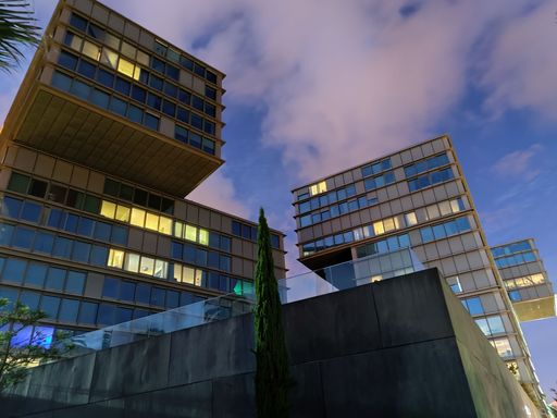 A low angle shot of buildings in the evening