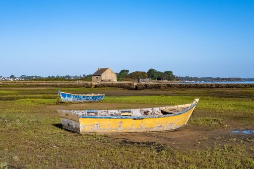 Arz island in the Morbihan gulf, the tide mill, with typical row boats, panorama