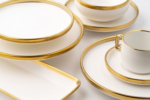 A Set of white and brown ceramic plate and cup on a white background