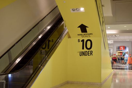 A closeup shot of an escalator and signs
