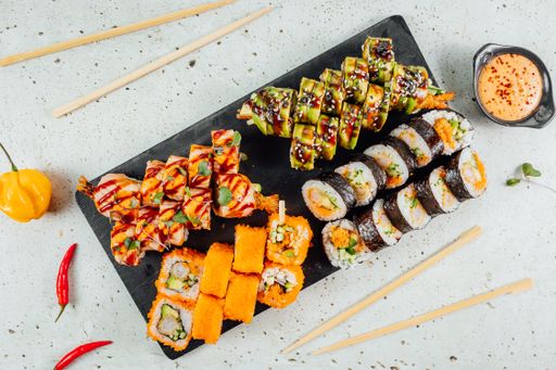 A top view of tasty and delicious sushi on a wooden board