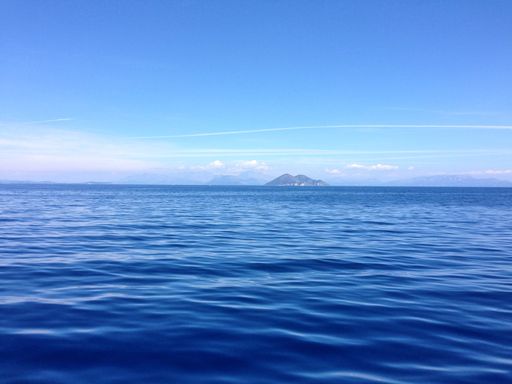 A beautiful shot of soft waves with mountains in the distance