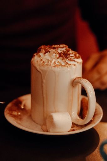A vertical shot of a cup of hot chocolate with whipped cream