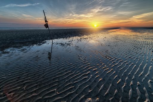 A breathtaking early morning scenery of the sun rising over the ocean