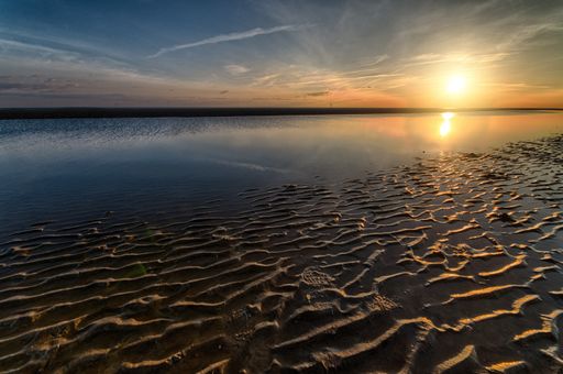A breathtaking early morning scenery of the sun rising over the ocean