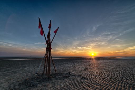 A formation displaying the concept of balance at the beach during sunrise