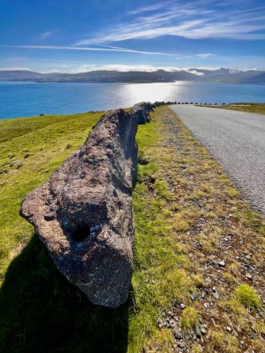 A close up of rock on an island with the blue ocean in the background