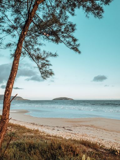 A beautiful shot of the sea in Rio de Janeiro beach during sunset with waves crashing